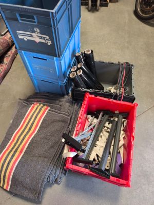 a pile of tools in a blue crate on the floor