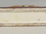 an image of a white and brown box with holes on it