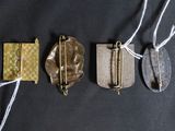 three different types of brooches on a black surface