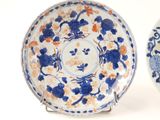 two blue and white plates with flowers on them