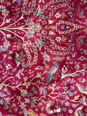 un gros plan sur un tapis rouge orné d'un motif floral