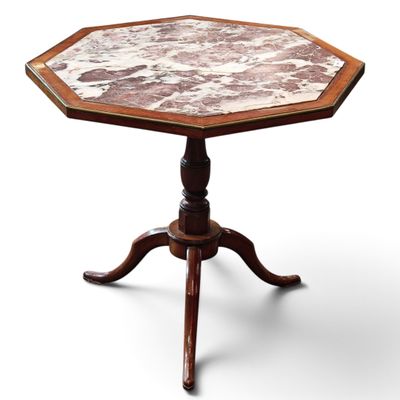 an octagonal table with a marble top on a wooden stand