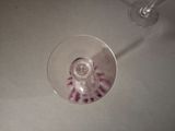 a wine glass sitting on a table next to a wine glass