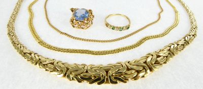 three pieces of jewelry sitting on top of a white surface
