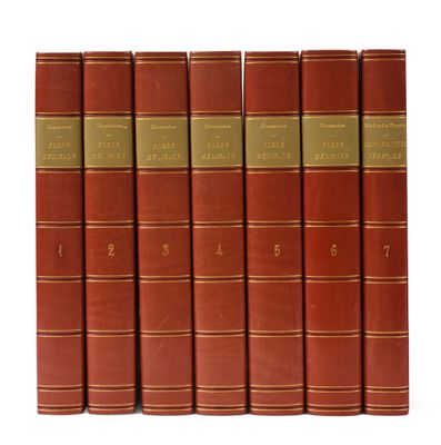 six livres rouges sont alignés sur une surface blanche
