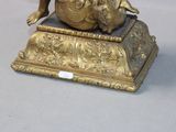 a gold statue of a woman sitting on top of a box