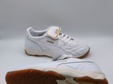 a pair of white and orange sneakers on a white background