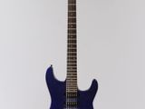 an electric guitar hanging from a string on a white wall