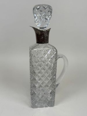an old fashioned glass bottle with a wooden stopper on top of it