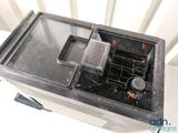 a dirty toaster oven sitting on top of a white table