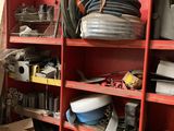 a red shelving with lots of tools and supplies on it