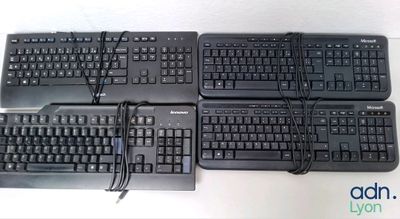four keyboards sitting on top of each other on a table