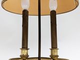 pair of brass table lamps with shades on each of them