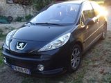 a picture of a small black car parked on the side of the road