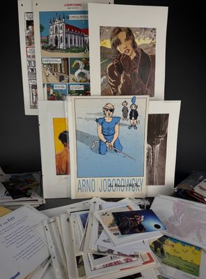 a pile of books and pictures on a table
