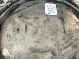 a close up of a silver plate with a sticker on it