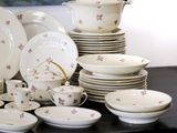 a lot of dishes and cups on the table