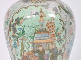 a vase with a lid that has a picture on it