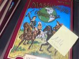 un livre posé sur la table, sur lequel est posée une note