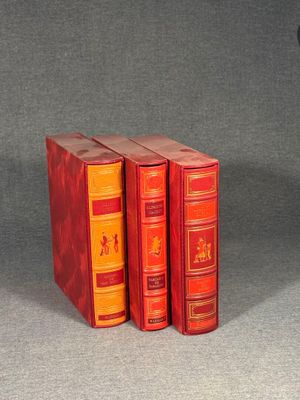 three books sitting on top of each other on a table