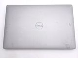 dell laptop computer sitting on top of a white table with a dell logo on it