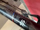 a close up of a bike with a bottle of wine on it