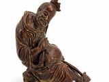 an image of a statue of a man sitting on the ground