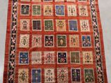 an orange and blue rug with a patchwork design on it