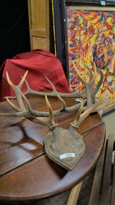 a wooden table with antlers on top of it