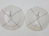 two plates with scissors on them sitting on a table