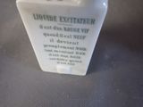 a small white vase with a black and white label on it