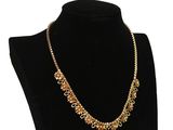 un collier avec une chaîne en or sur un mannequin noir