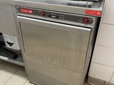 a silver dishwasher sitting in the middle of a kitchen