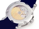 a close up of a watch on a white surface