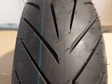 a close up of a motorcycle tire on a tile floor