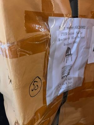 a box with a sign attached to it sitting on the floor