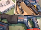 two electric tools that are sitting on a table