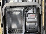 a black case with electronics inside of it on the ground