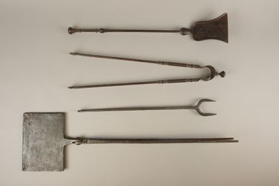 several old tools are arranged on a white surface with a white background