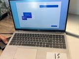 someone is working on a laptop computer on a desk in an office