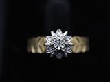 a close up of a diamond ring on a black surface