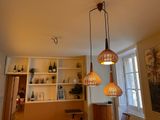 three lights hanging from the ceiling in a room