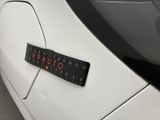 a car with a ruler attached to it ' s side