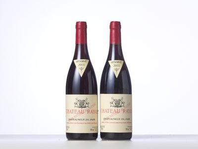 two bottles of red wine sitting on top of a table