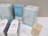 three boxes of perfume sitting on top of a table next to a box of soap
