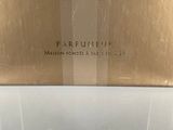 an image of a box of perfume sitting on top of a counter