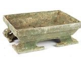 a small green planter sitting on top of a table