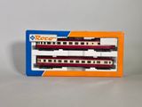 a red and white train in a box on a table