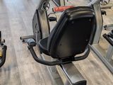 many stationary exercise bikes in a gym room