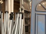 many ladders that are leaning against a door